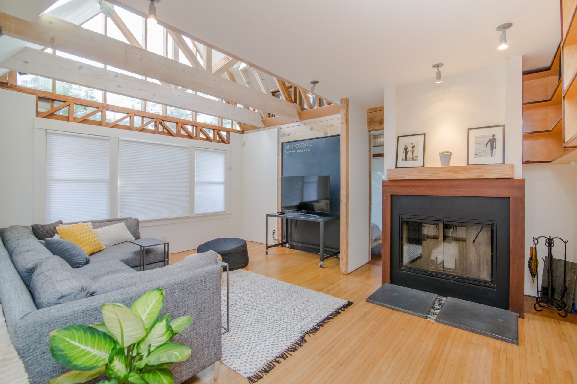 A living room with a fireplace and wooden floors