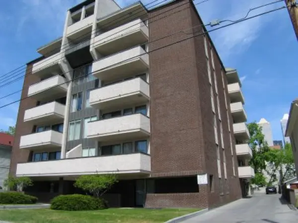 A large brick building with many windows and balconies.