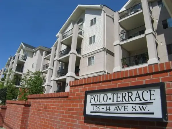 A brick wall with the words " polo terrace 2 6-1 4 ave sw ".