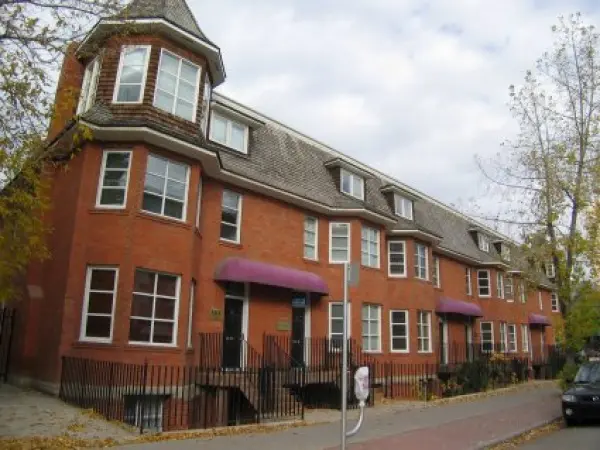 A row of brick buildings with a purple roof.