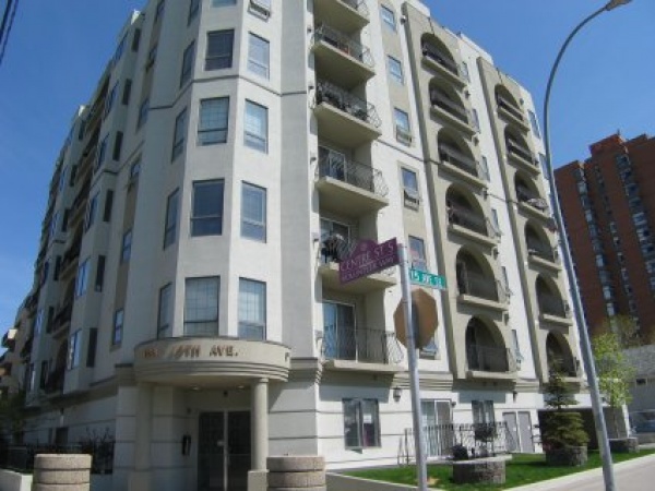 A large white building with many windows and balconies.