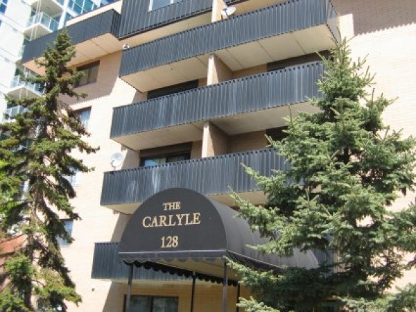 A building with many windows and trees in front of it